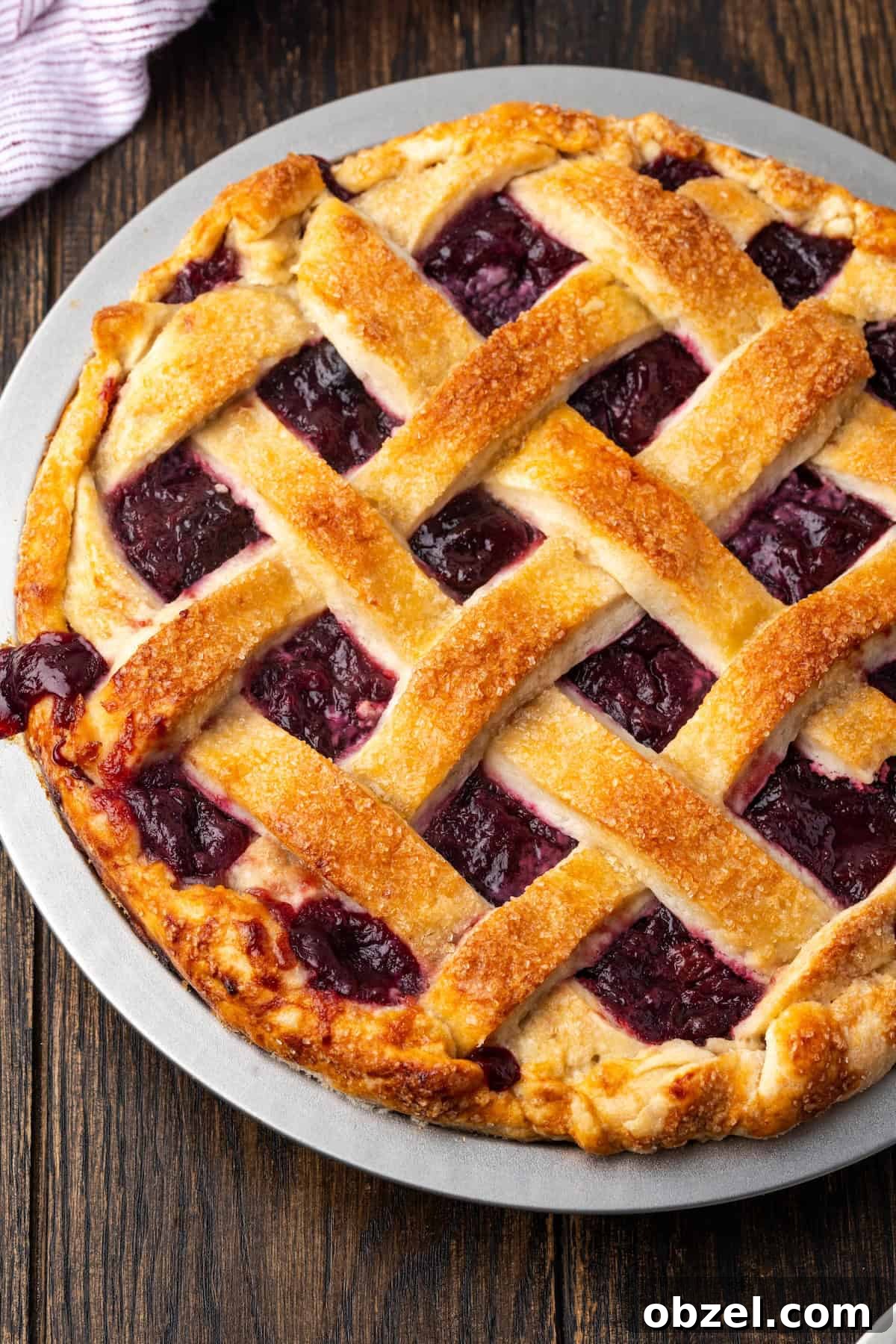 Baked homemade cherry pie with lattice crust. Overhead view of baked cherry pie with a lattice crust.
