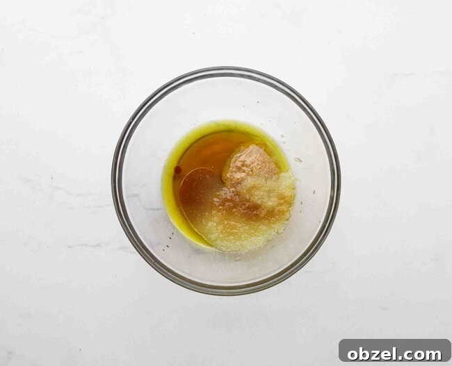 Olive oil, maple syrup, and applesauce in a bowl.