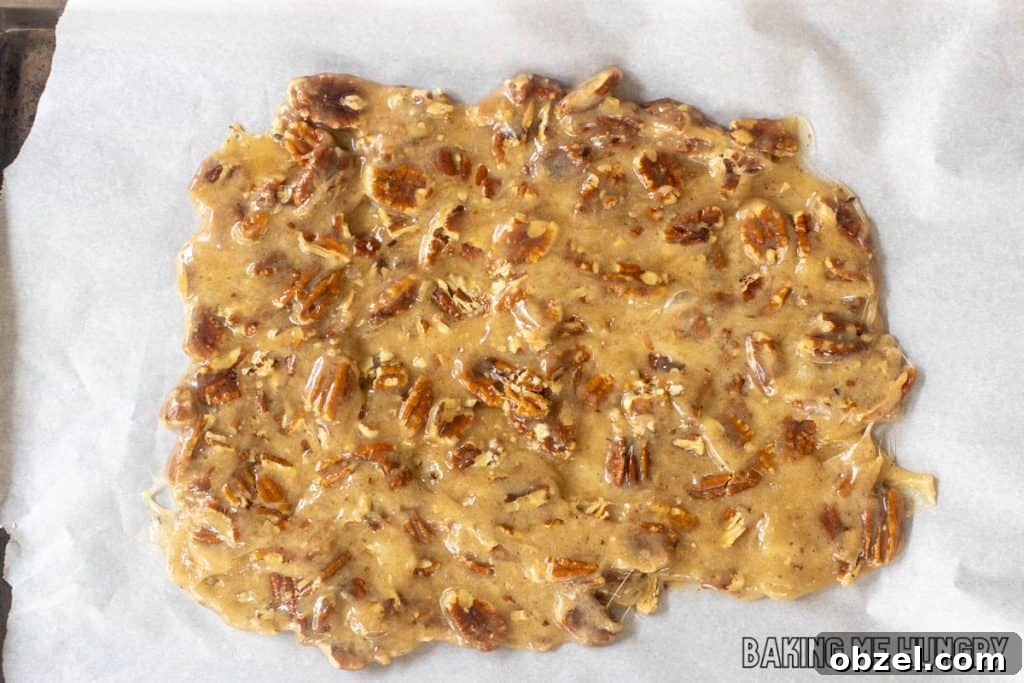 Old Fashioned Pecan Brittle Recipe 9 parchment lined tray with candy spread on top