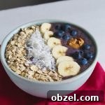 Homemade acai-inspired smoothie bowl with blueberries, banana, almond milk, and toppings