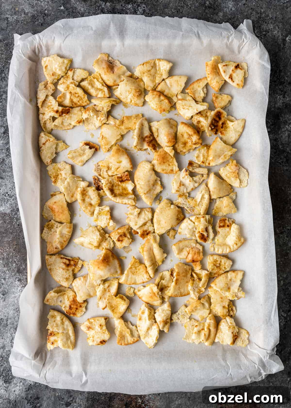 Fatteh with Crispy Pita Hummus and Yogurt 8 overhead process shot: pieces of pita bread on parchment paper