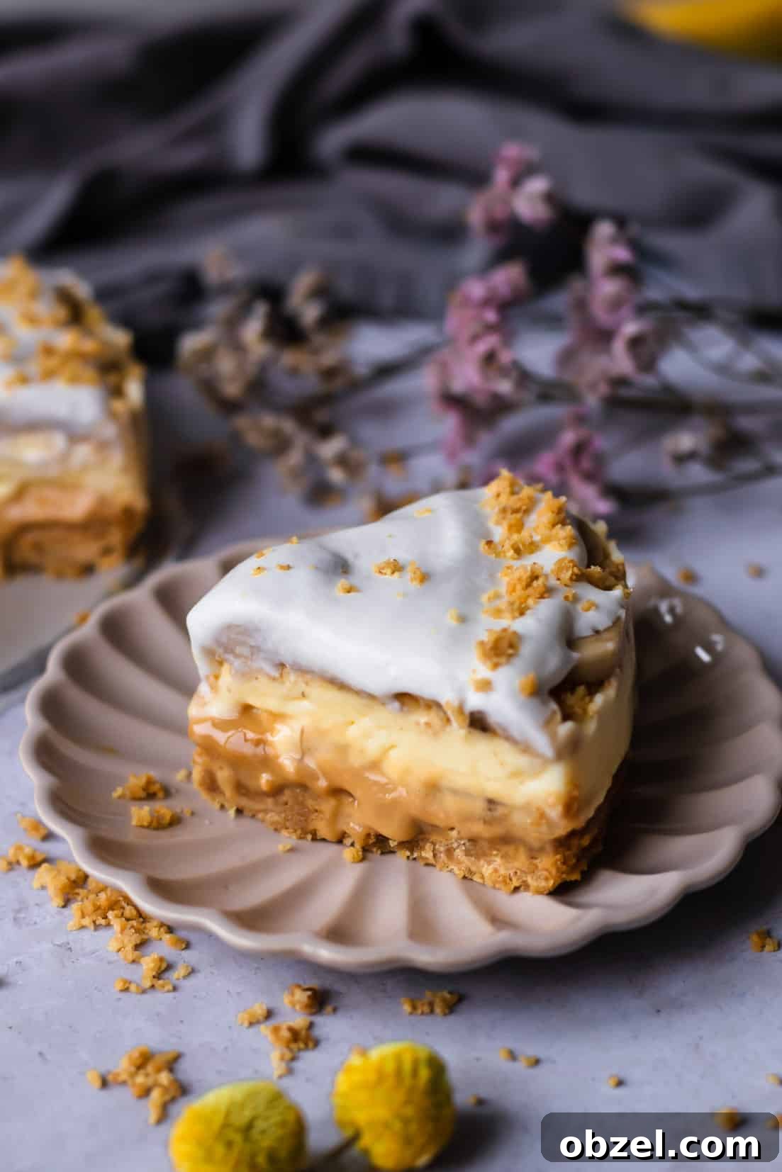 Banoffee Cream Pie with Dulce de Leche and Bananas 12 a slice of banoffee pie on a beige plate