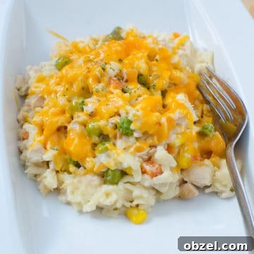 Chicken Orzo Casserole on a white plate with a fork