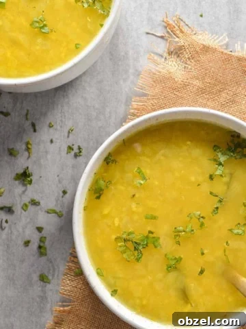 Two bowls of yellow soup on burlap