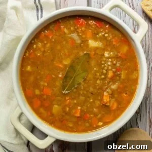 Traditional Spanish Lentil Stew with Chorizo 16 A white casserole dish with lentil stew in it.