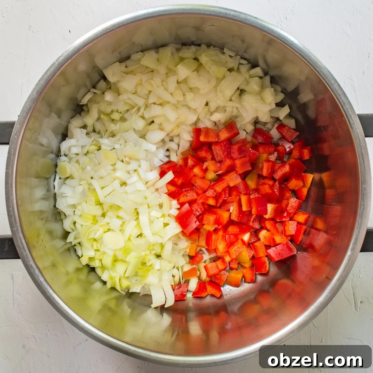 Traditional Spanish Lentil Stew with Chorizo 5 Chopped leeks, onions and red bell pepper in a large pan.