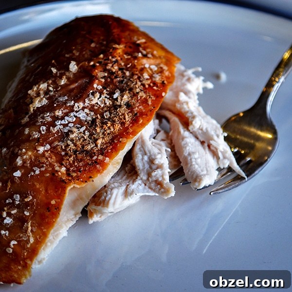 How to Roast Chicken 2 Foolproof Methods for Juicy Results 5 A slice of perfect roast chicken on a plate with a fork.