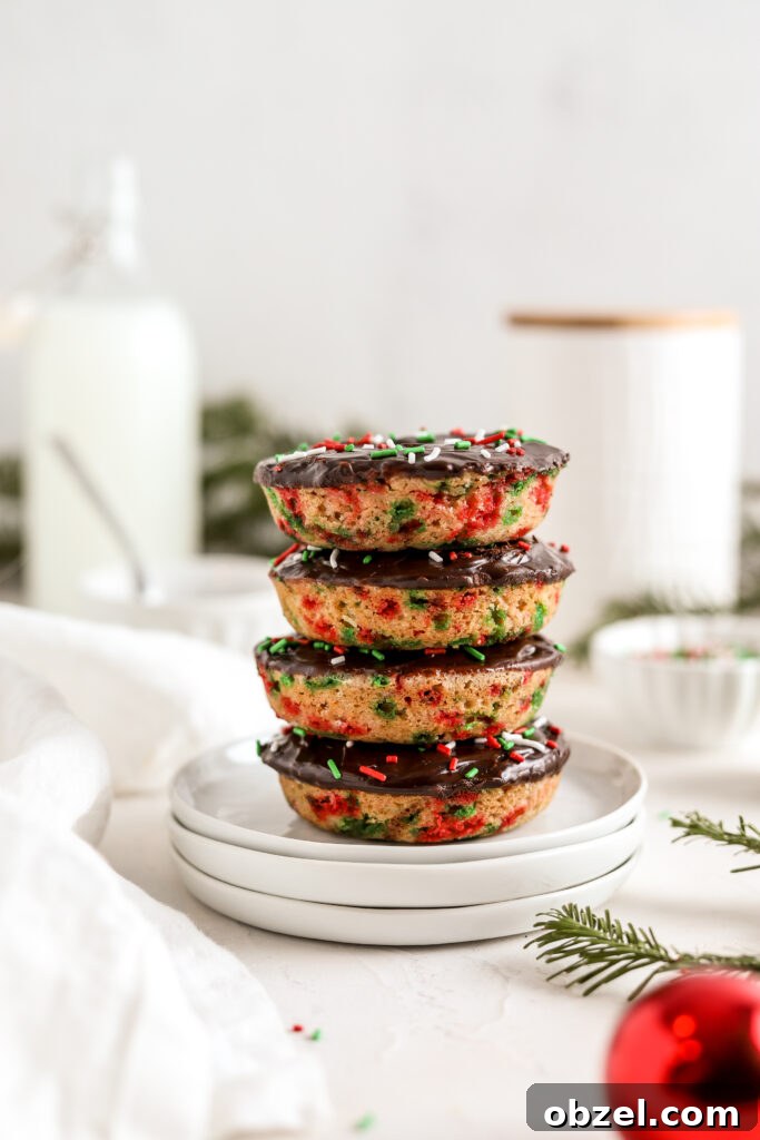 Festive Christmas Donuts for Holiday Baking 6 Stack of Christmas donuts with chocolate ganache and sprinkles