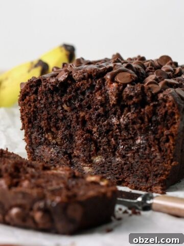 Chocolate banana bread sliced with a knife