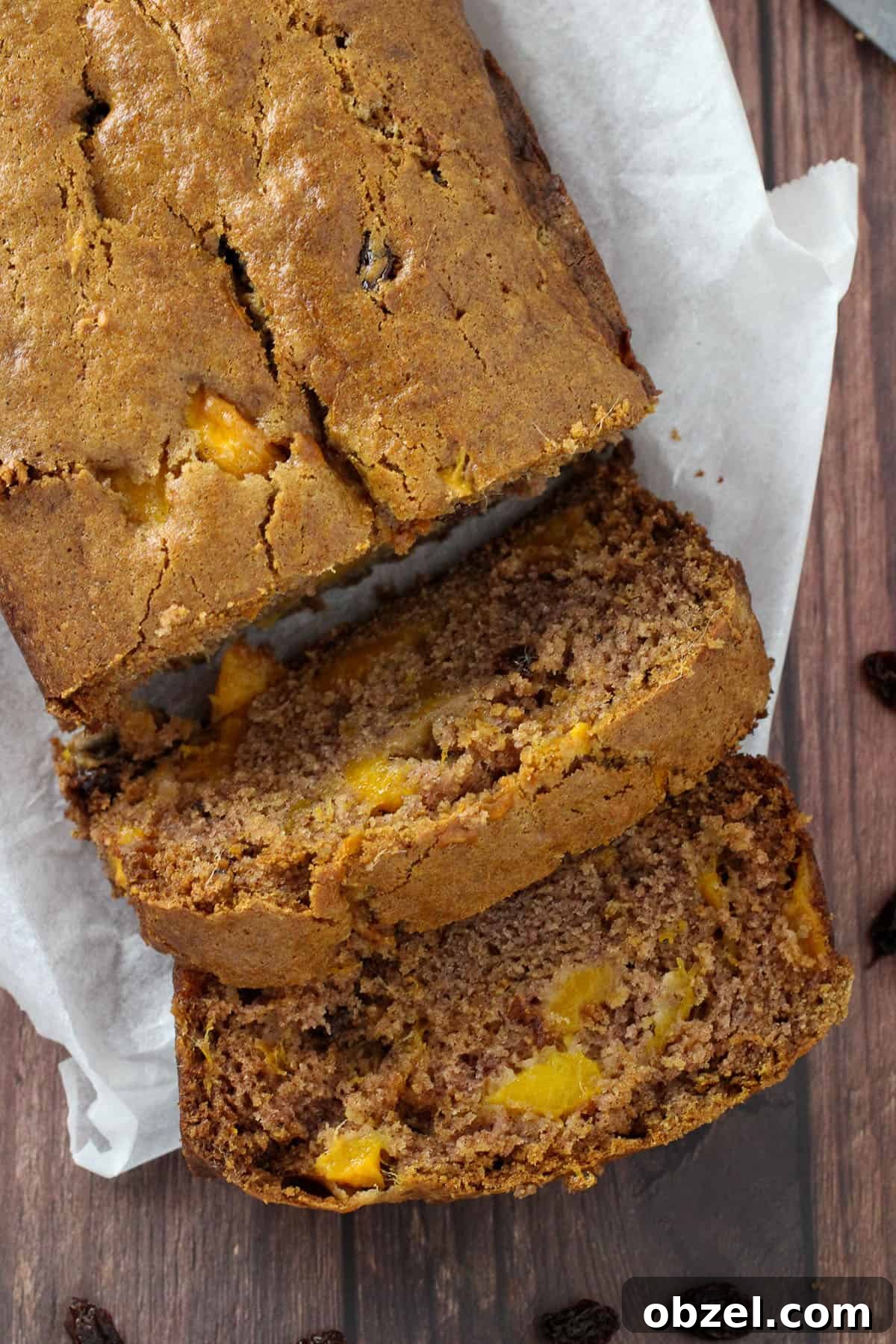sliced mango bread loaf on a white cutting board