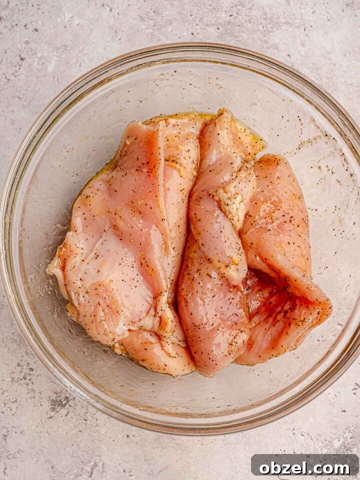Marinated chicken in a clear bowl.