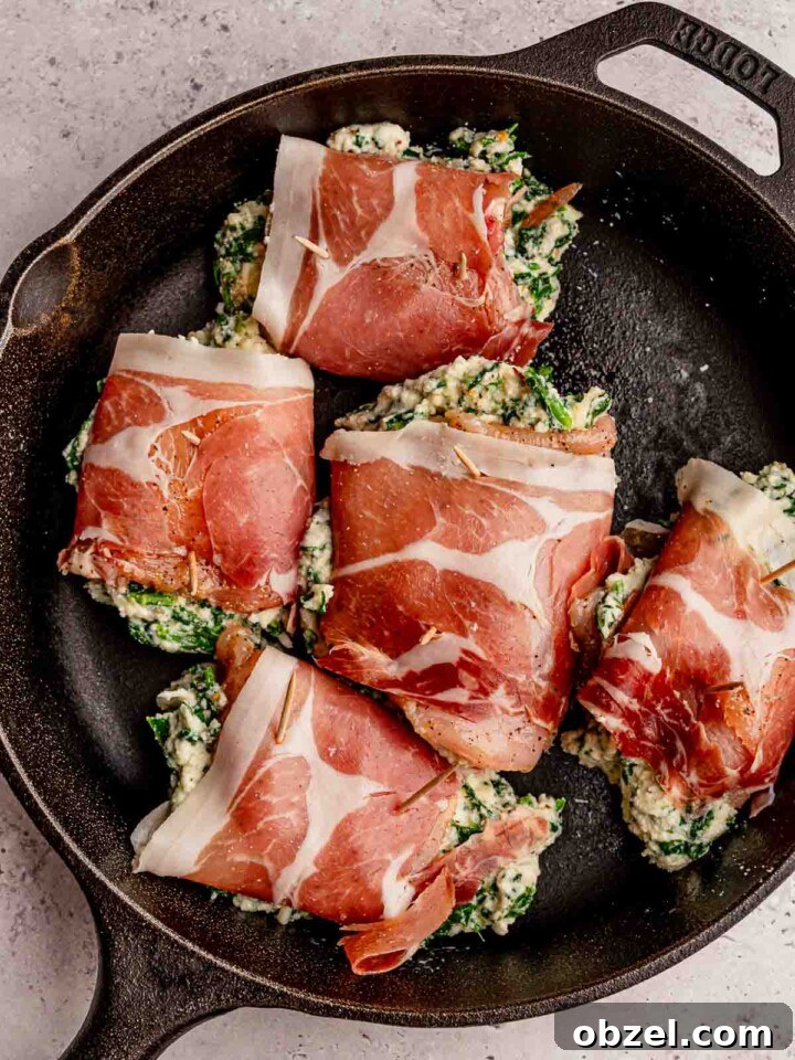 Chicken wrapped in prosciutto before cooking.