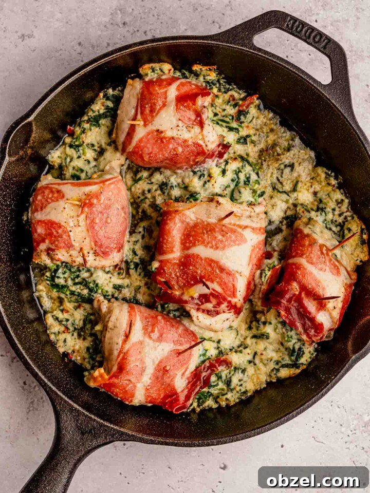 Prosciutto wrapped chicken in a skillet.