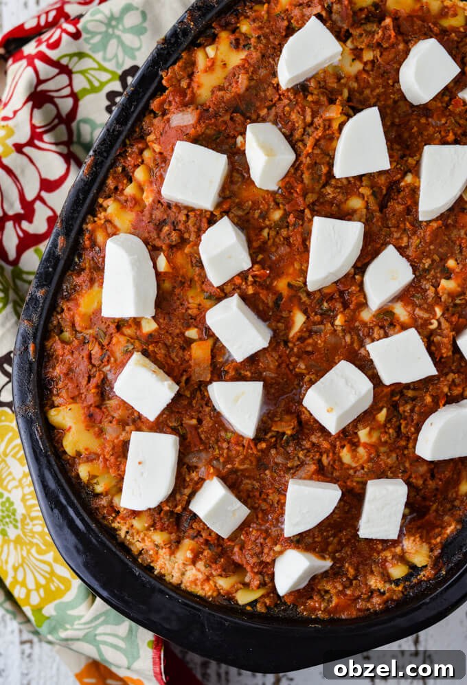 Crock Pot Lasagna Recipe with Meat Sauce 11 Crock pot lasagna topped with cubed fresh mozzarella before melting.