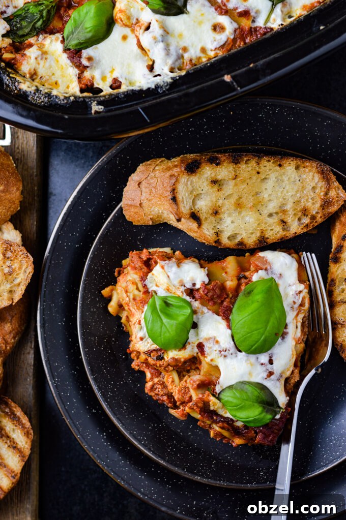 Crock Pot Lasagna Recipe with Meat Sauce 13 Slice of homemade crock pot lasagna served with toasted garlic bread.