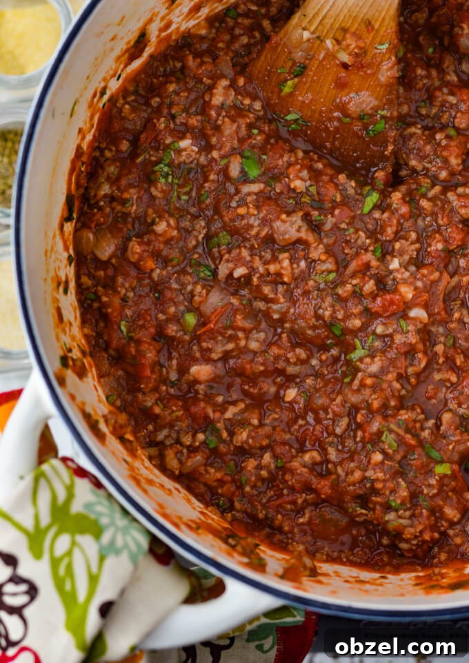Crock Pot Lasagna Recipe with Meat Sauce 7 Homemade meat sauce for crock pot lasagna in a Dutch oven.
