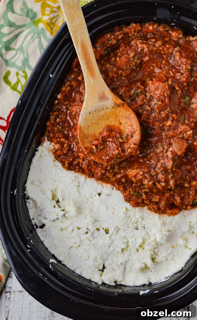 Crock Pot Lasagna Recipe with Meat Sauce 10 Layering cheese mixture and sauce for crock pot lasagna.