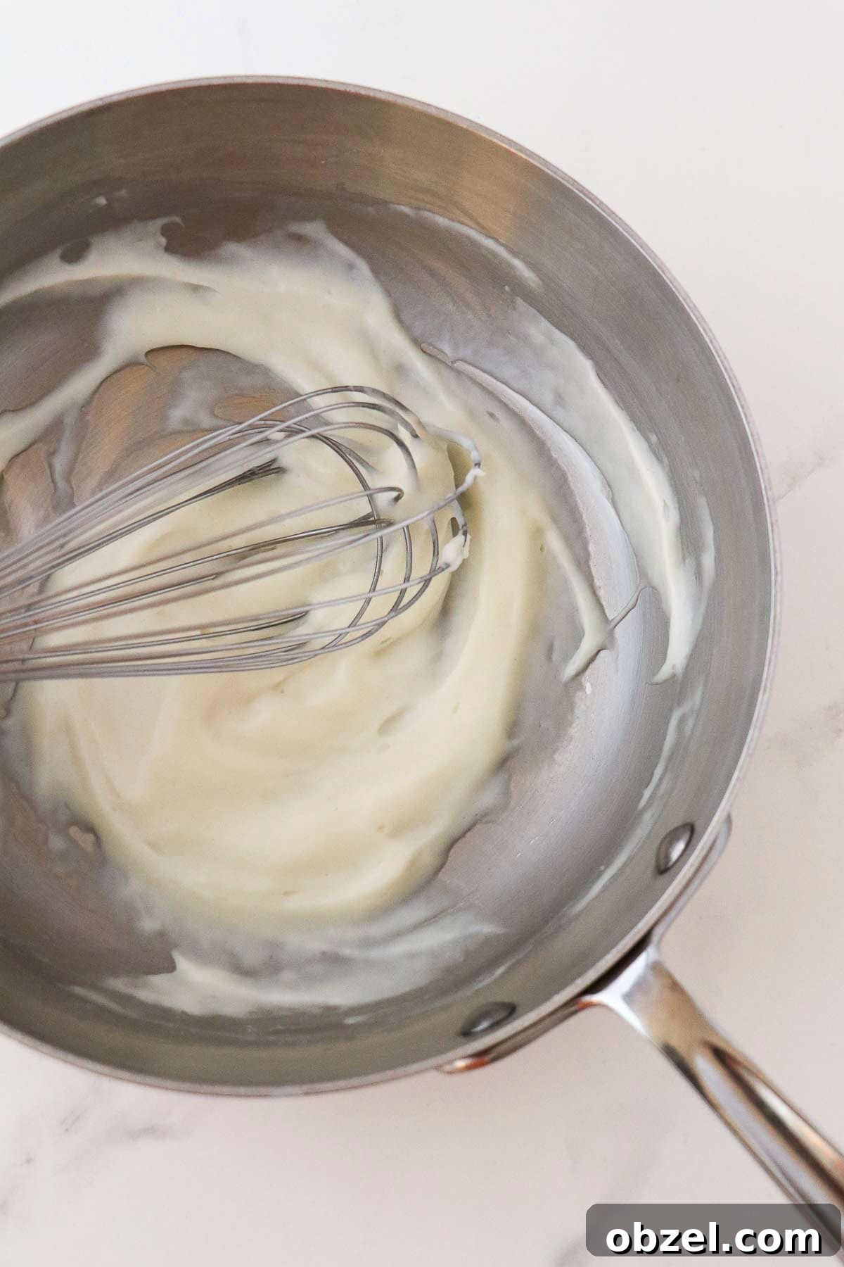 Fastelavnsboller: Norwegian Lenten Buns Recipe 4 Tangzhong in a metal saucepan with a whisk.