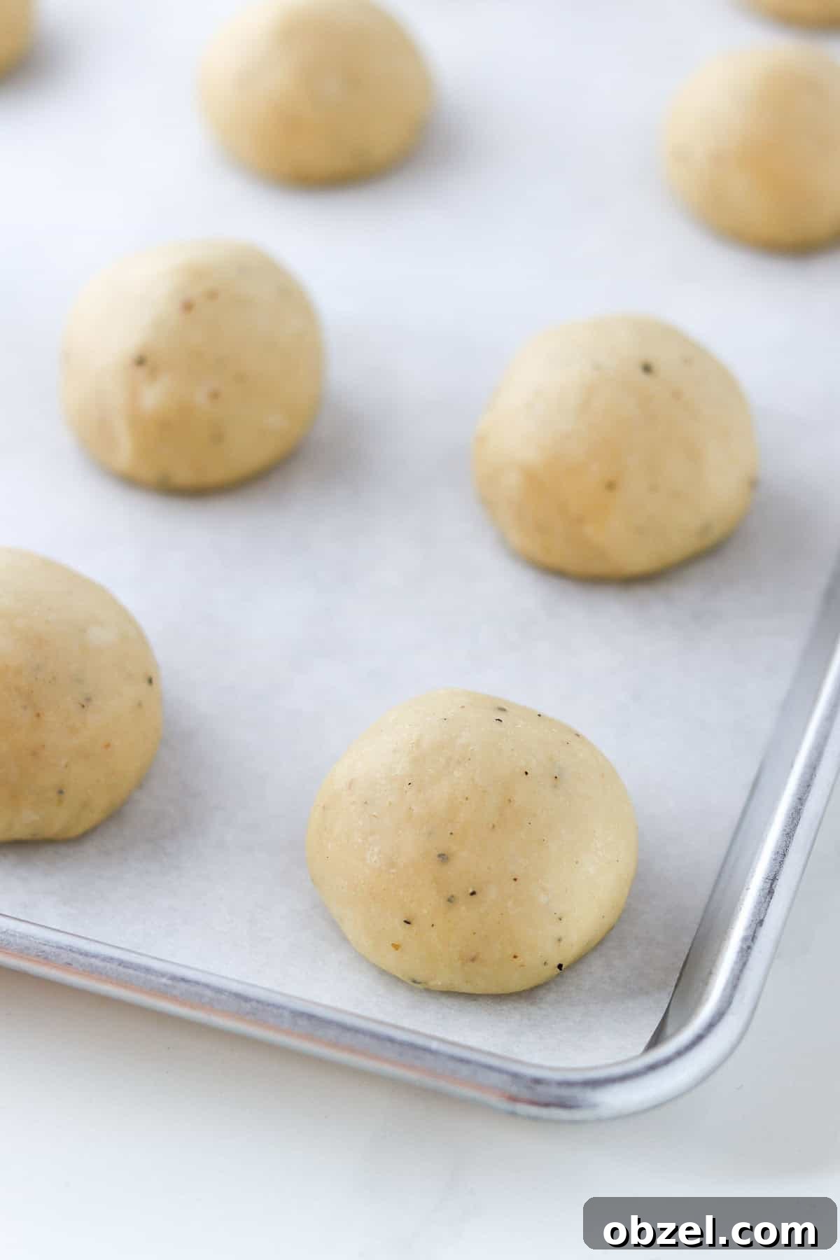 Fastelavnsboller: Norwegian Lenten Buns Recipe 8 Shaped and unbaked Fastelavnsboller (Norwegian Lenten Buns) on a baking sheet.