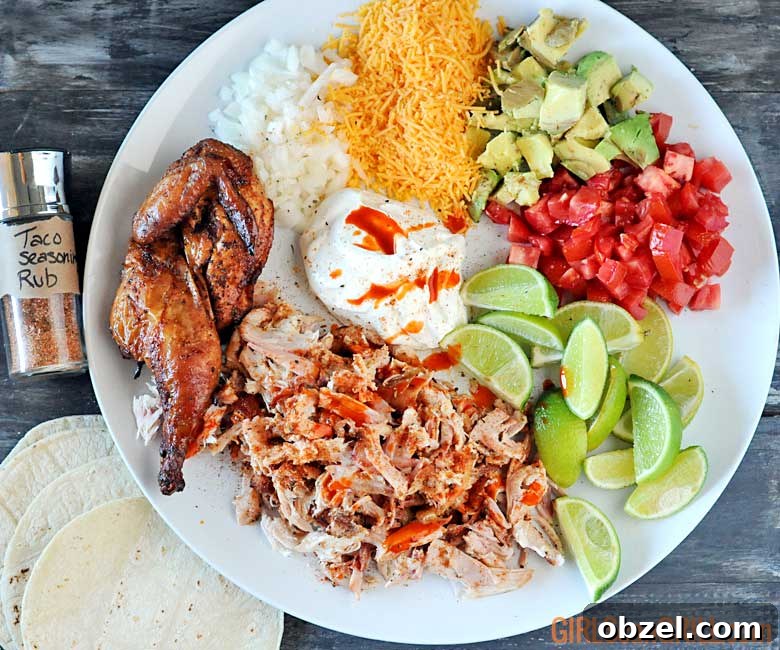 white plate with grilled chicken, cheese, onions, tomatoes, limes and sour cream
