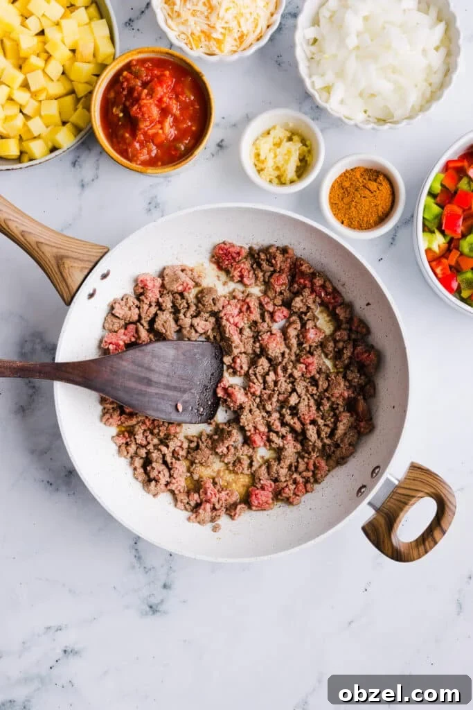 High-Protein Cheesy Taco Potato Casserole 5 Ground beef being sautéed in a pan.