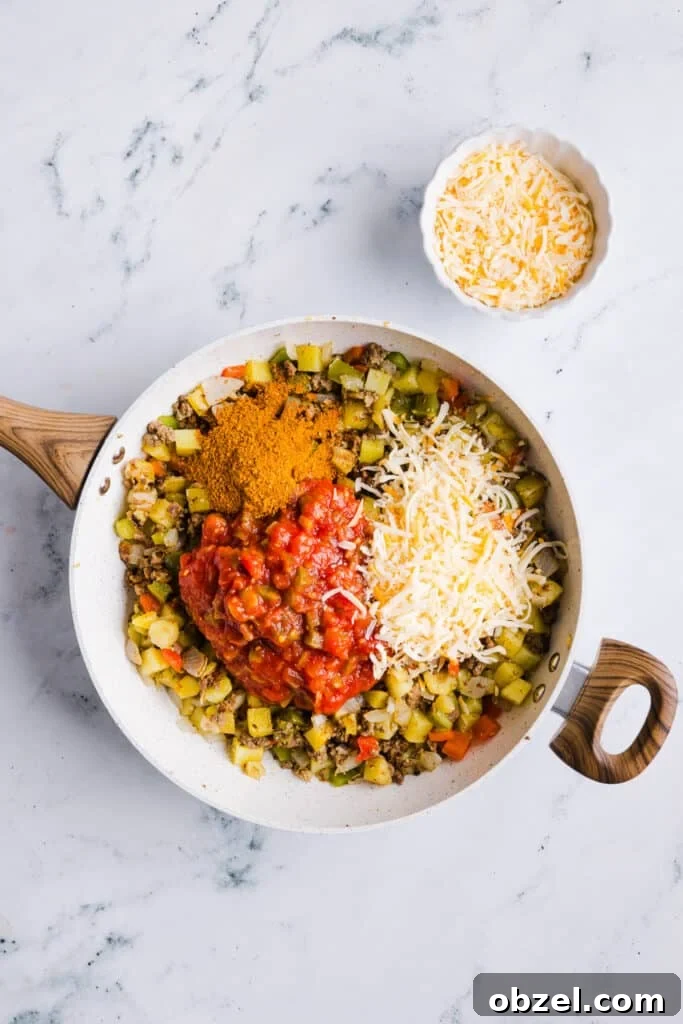 High-Protein Cheesy Taco Potato Casserole 7 Salsa, shredded cheese and taco seasoning being added to sautéed veggies, potatoes and ground beef.