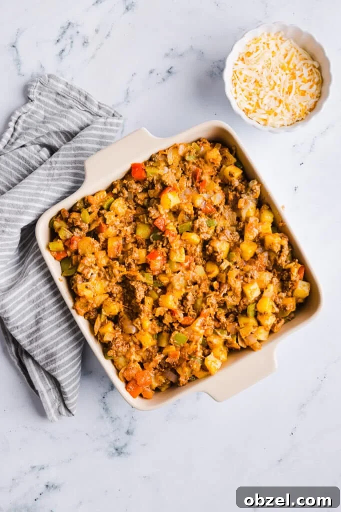 High-Protein Cheesy Taco Potato Casserole 8 Taco potato casserole mixture in a baking dish.