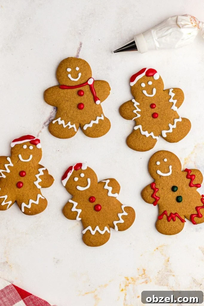 Air Fryer Gingerbread Cookies Recipe 11 Golden gingerbread men cookies on a marble table being frosted