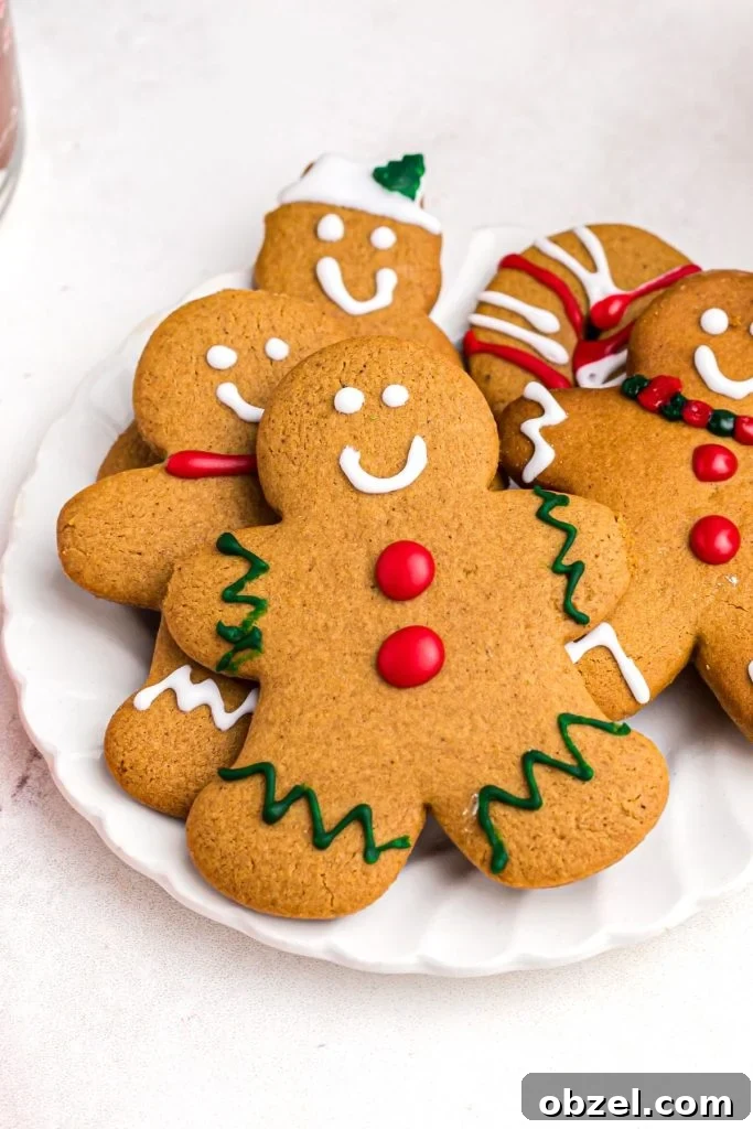 Air Fryer Gingerbread Cookies Recipe 12 Golden gingerbread man cookie on a white plate