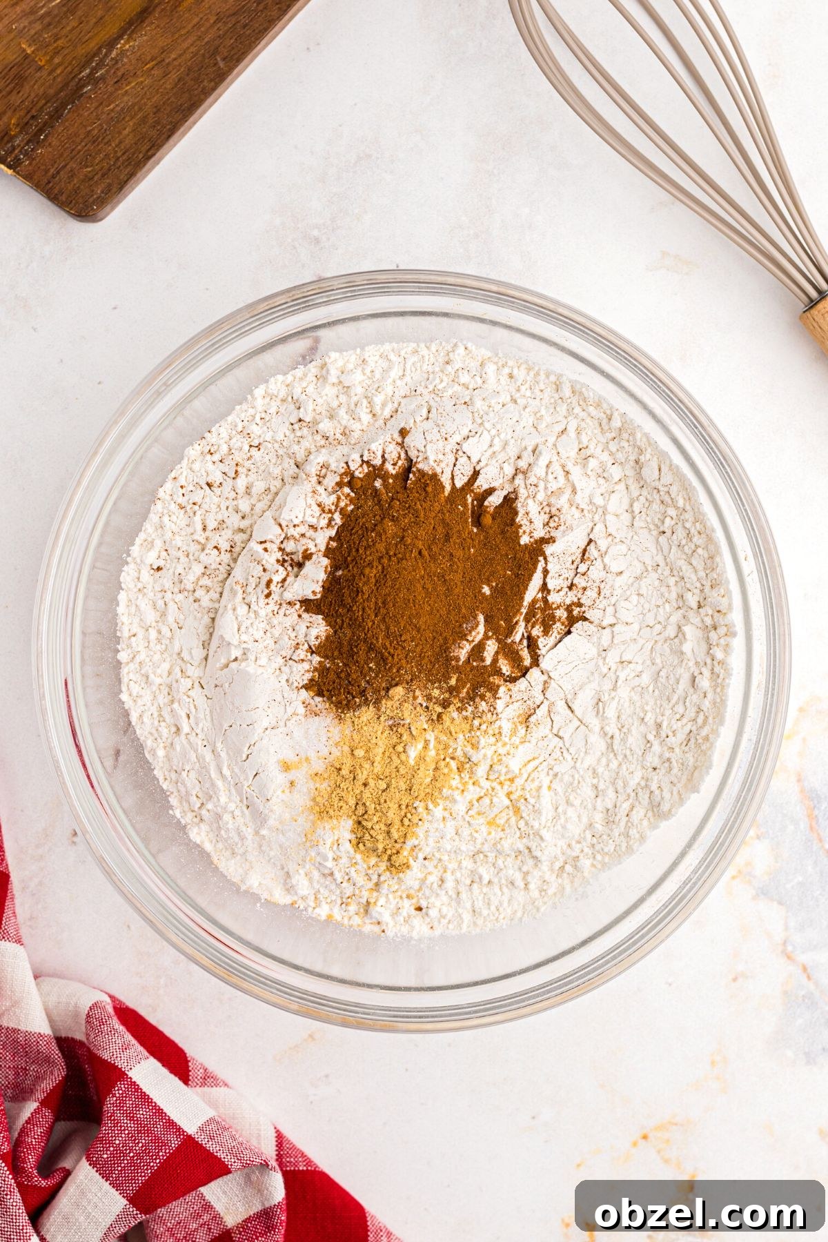 Air Fryer Gingerbread Cookies Recipe 5 flour, cinnamon, and other seasonings being mixed in a clear bowl