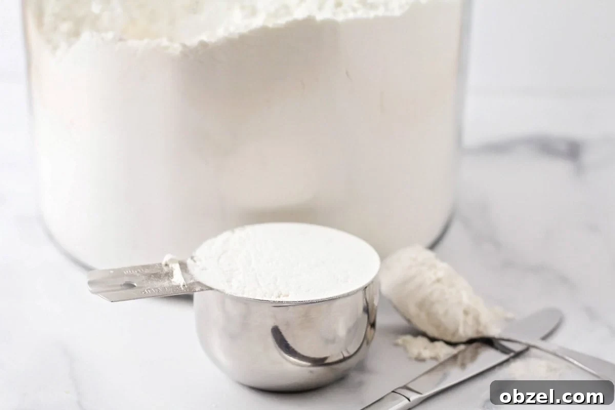 Homemade Italian bread made with simple ingredients. Measured flour on a kitchen counter.
