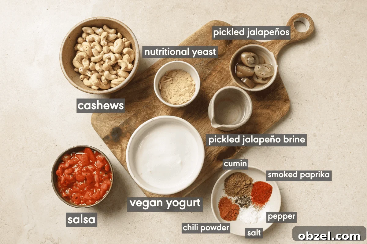 Creamy Vegan Queso Dip 4 vegan queso ingredients in various small bowls on a wooden cutting board.