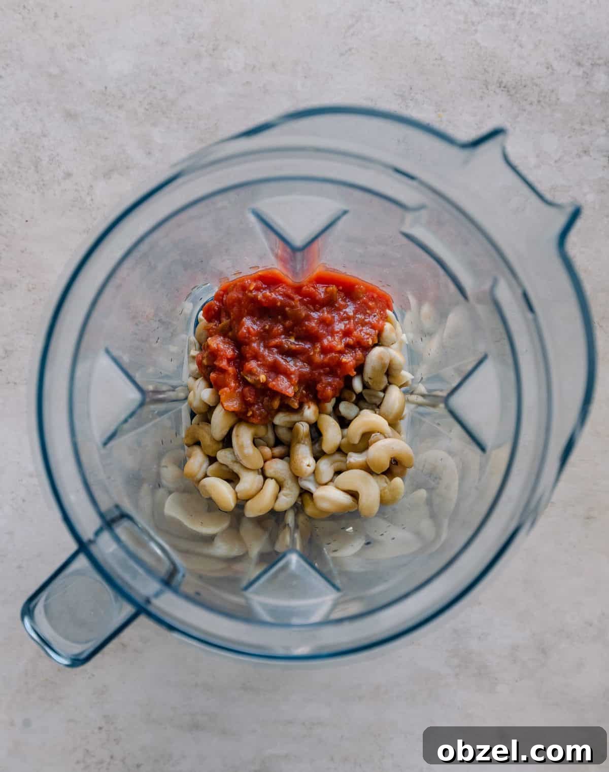 Creamy Vegan Queso Dip 6 cashews and salsa in a blender.