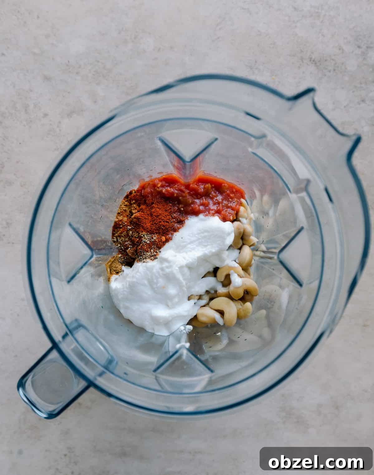 Creamy Vegan Queso Dip 7 cashews, salsa, yogurt, and spices in blender.