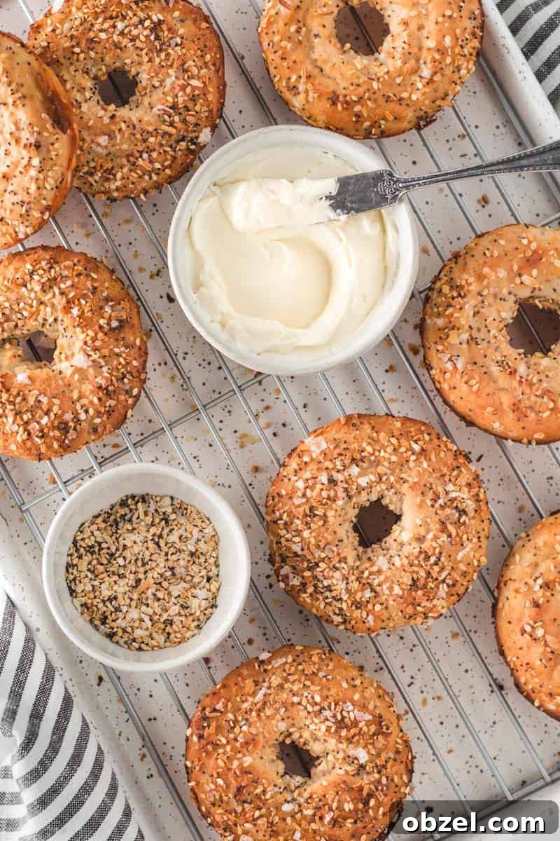 2-Ingredient Gluten-Free Bagels Recipe 2 Two-Ingredient gluten free bagels on a cooling rack with cream cheese and everything bagel seasoning.