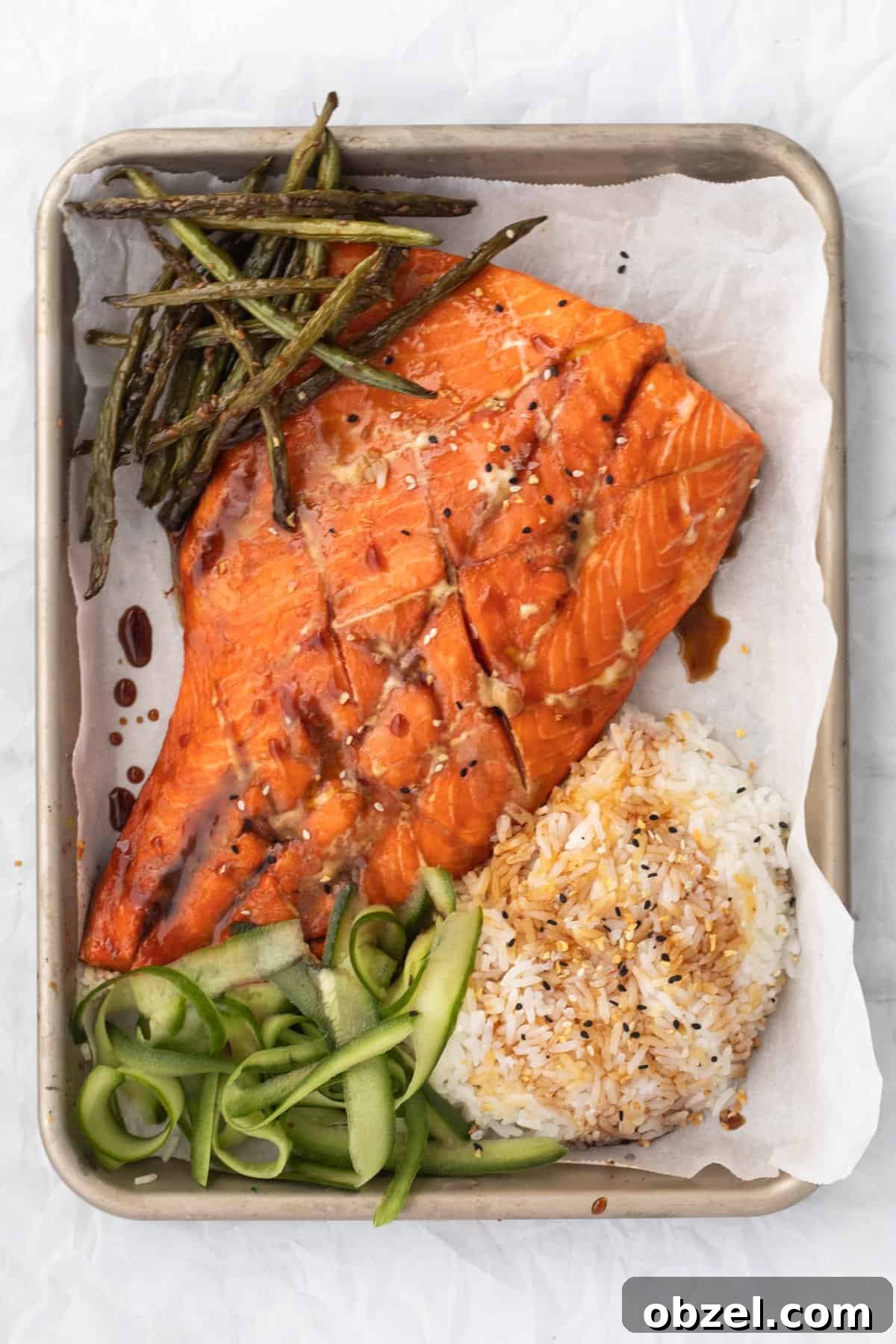 Teriyaki Salmon on a sheet pan with rice and vegetables.