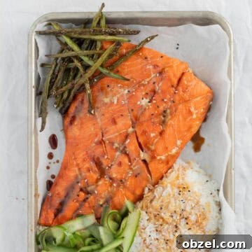 Teriyaki Salmon on a sheet pan with rice and vegetables.