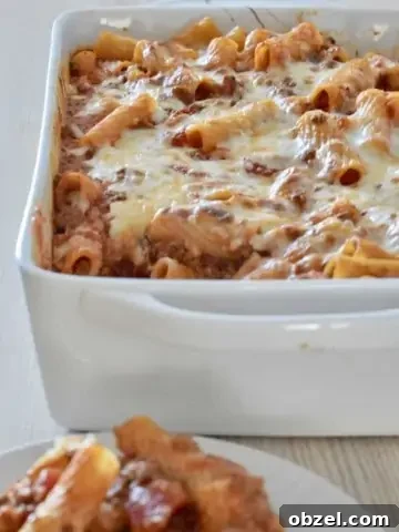 Baked Ziti with meat sauce in a white baking dish.