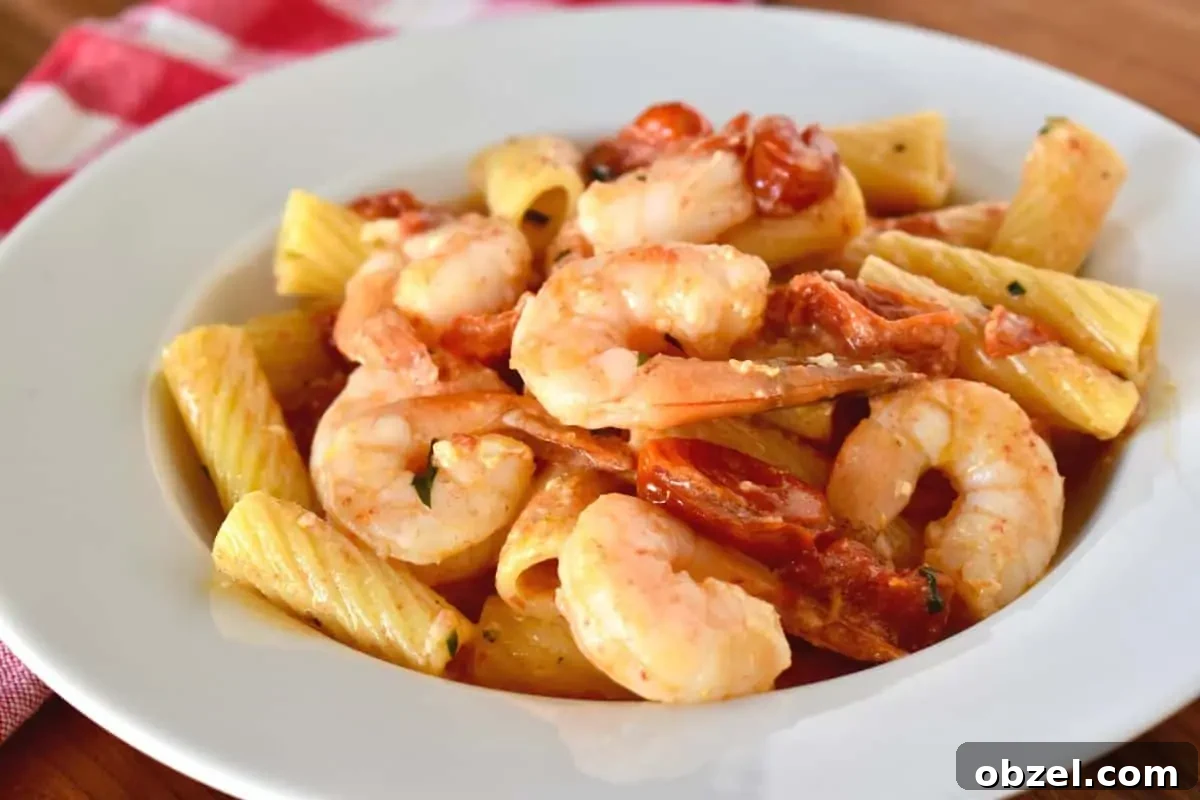 Creamy Baked Feta Pasta with Garlic Shrimp 3 white bowl of pasta with shrimp with a red checkered napkin in the background.
