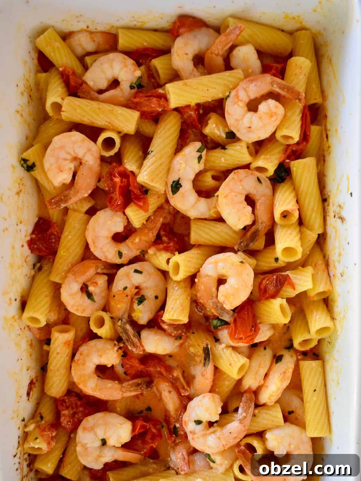 Creamy Baked Feta Pasta with Garlic Shrimp 7 overhead photo of baked feta pasta with shrimp in a white casserole dish.