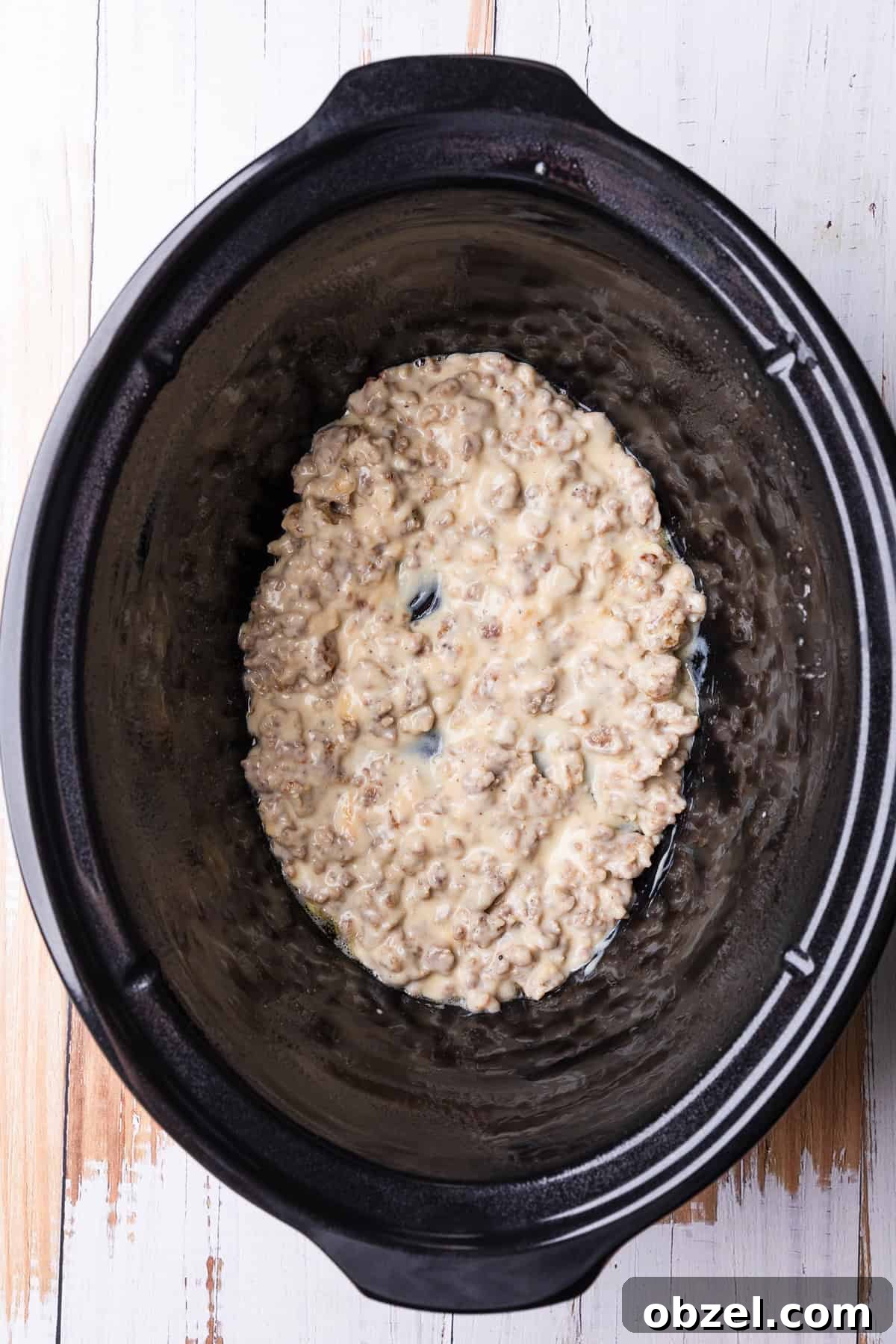 Slow Cooker Biscuits and Sausage Gravy Casserole 6 A layer of gravy in the crockpot.