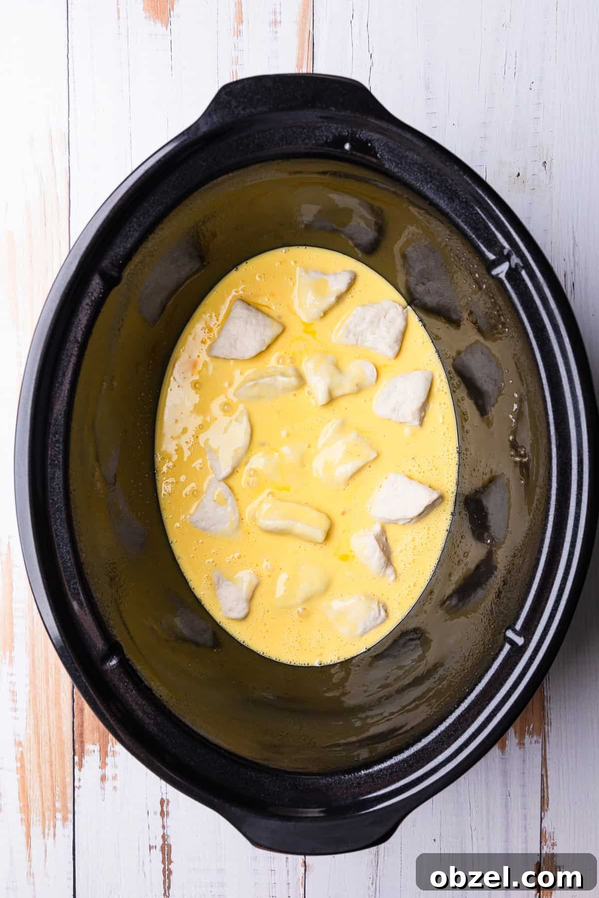 Slow Cooker Biscuits and Sausage Gravy Casserole 8 The beaten eggs added to the crockpot.