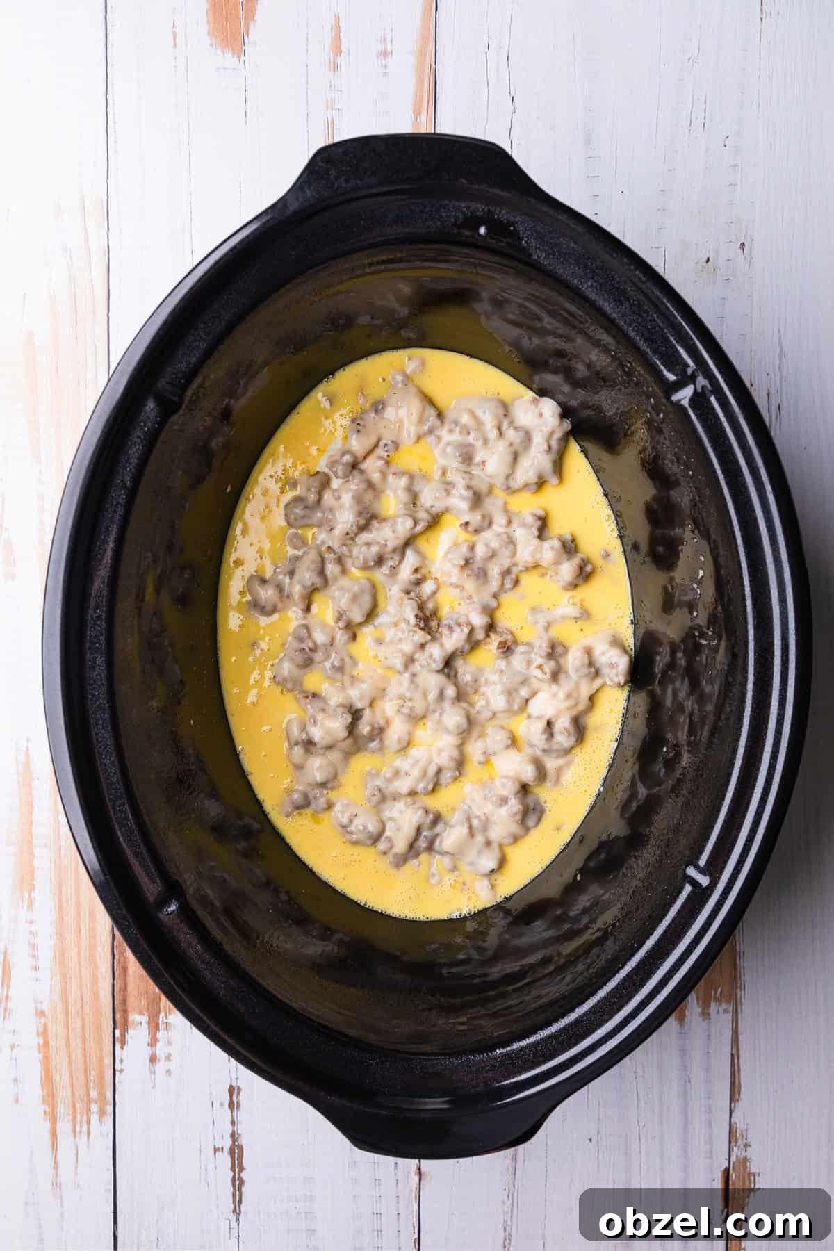 Slow Cooker Biscuits and Sausage Gravy Casserole 9 Adding another layer of gravy.