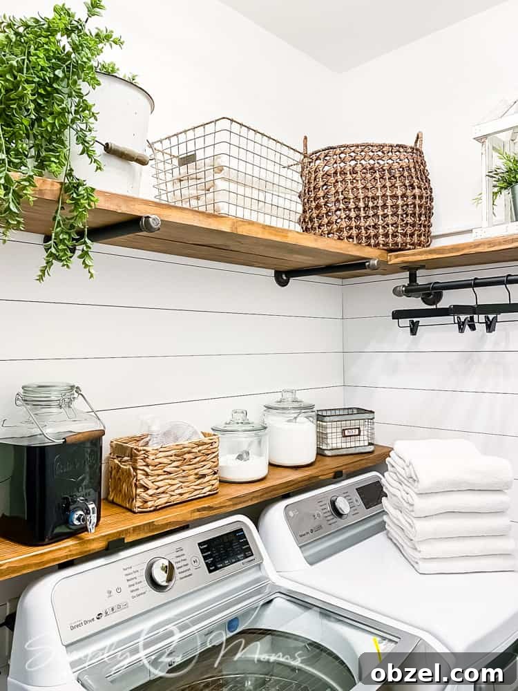 Stunning Before and After Laundry Room Makeover 11 diy wood and plumbing pipe shelving over washer and dryer in laundry room with storage baskets and laundry essentials on shelves