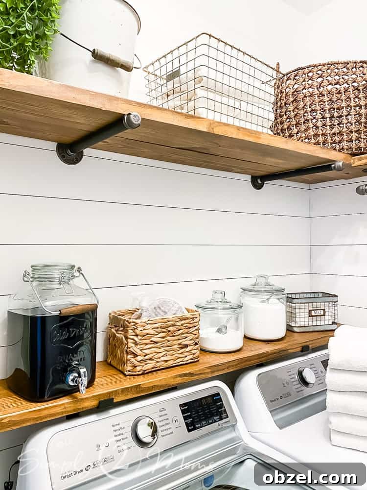 Stunning Before and After Laundry Room Makeover 14 laundry room wood and black iron pipe shelves with baskets and glass storage items for laundry supplies on shelves