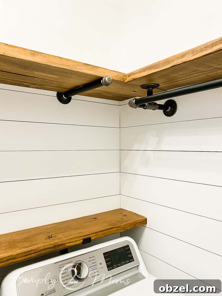 Stunning Before and After Laundry Room Makeover 24 two wood and pipe shelves meeting in corner of room with dryer below