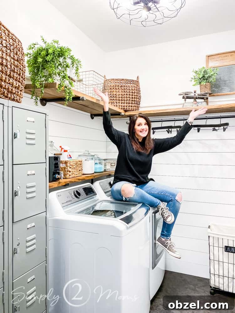 Stunning Before and After Laundry Room Makeover 5 woman sitting on dryer with wood shelves behind her and set of vintage lockers to left of photo