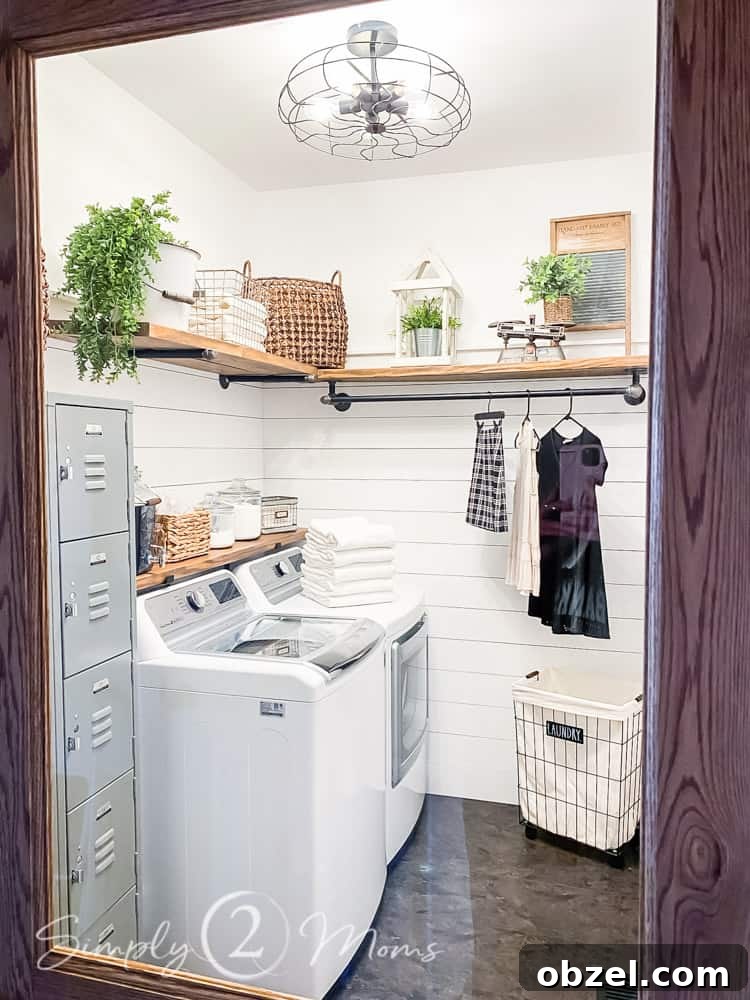 Stunning Before and After Laundry Room Makeover 6 view through glass window in top of wood door into room. lockers and washer and dryer on left side of room with wood shelves above appliances and shelf with hanging clothes rod on back wall
