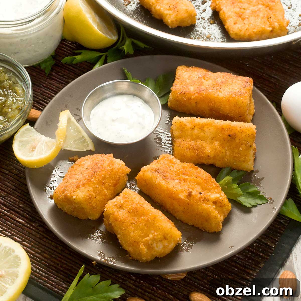 Gluten Free Breaded Fish with Homemade Tartar Sauce 2 Pan-fried cod on a plate with greek yogurt tartar sauce.