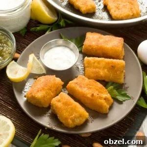 Pan-fried cod on a plate with greek yogurt tartar sauce.